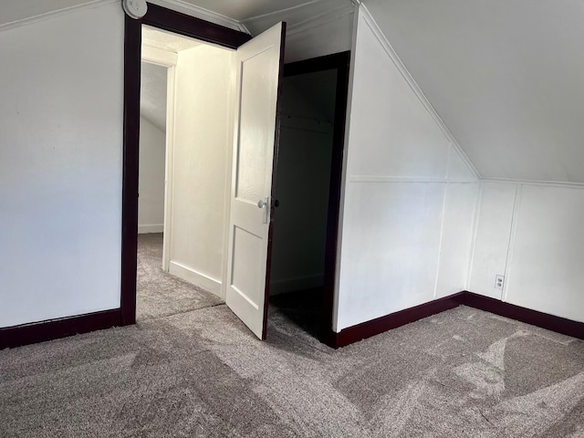 bonus room with carpet flooring and lofted ceiling