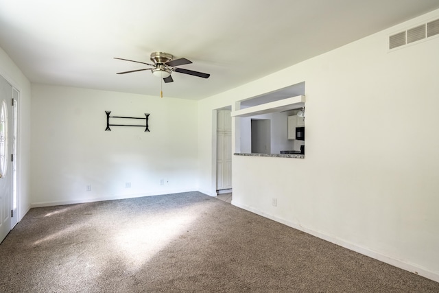 carpeted spare room featuring ceiling fan