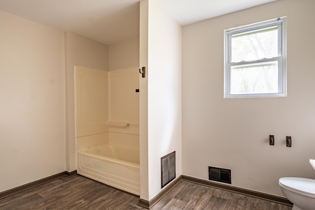 bathroom featuring hardwood / wood-style floors and toilet