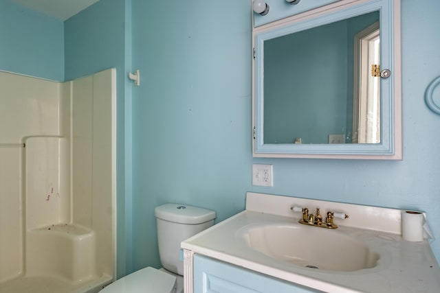 bathroom featuring vanity, toilet, and walk in shower