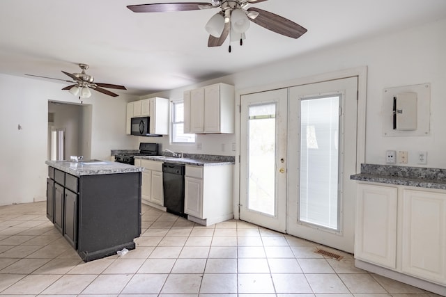 kitchen featuring a kitchen island with sink, french doors, white cabinets, and black appliances