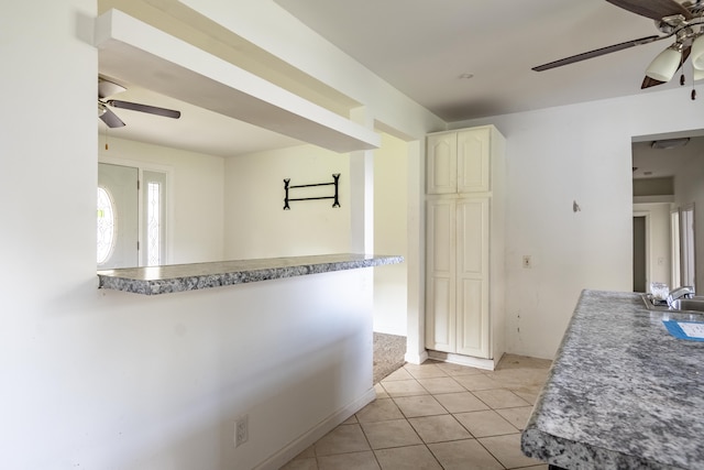 kitchen featuring ceiling fan and light tile patterned flooring