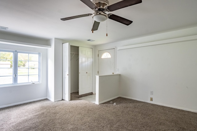 unfurnished bedroom featuring light carpet and ceiling fan