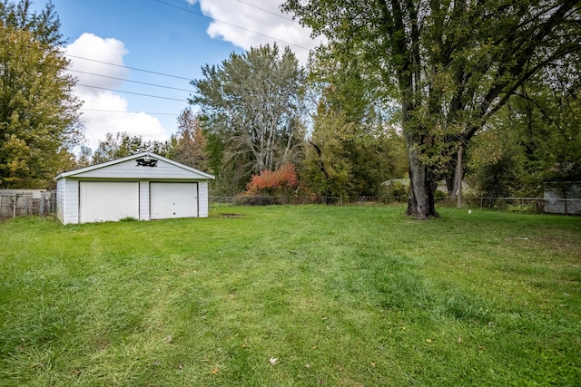 view of yard featuring an outbuilding and a garage