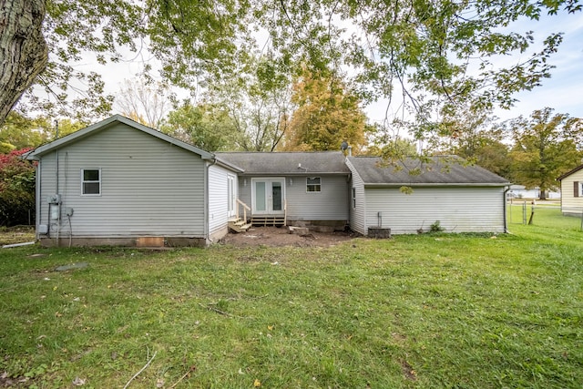 back of house featuring a yard