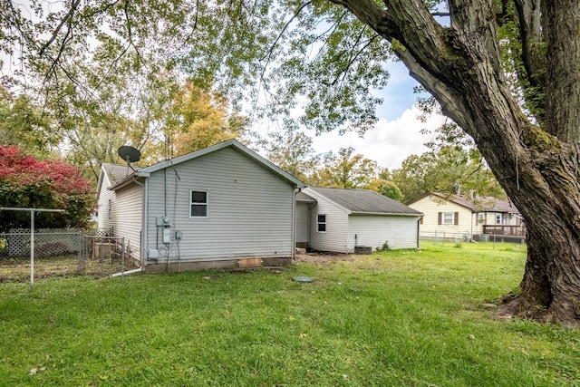 rear view of house with a lawn