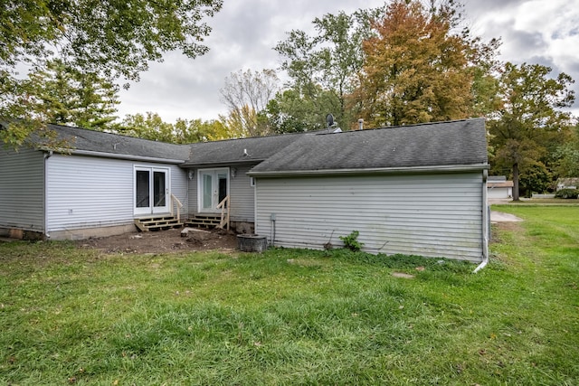 rear view of property with a yard