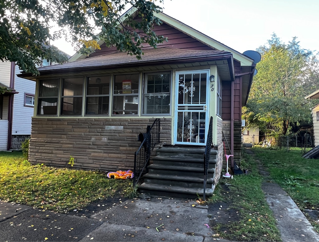 bungalow-style home with a sunroom