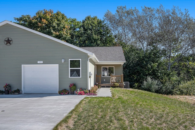 ranch-style home featuring a front lawn, a garage, covered porch, and central AC