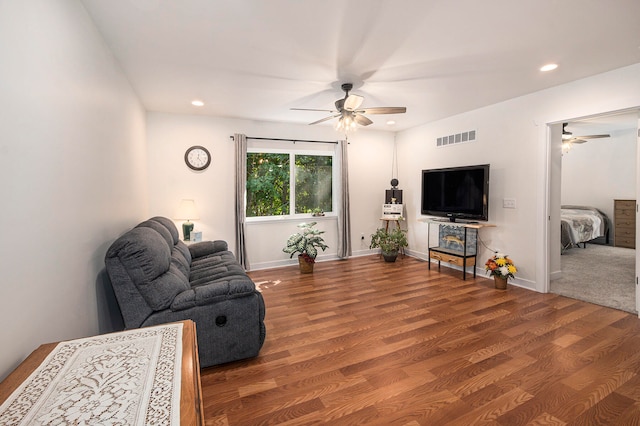 living room featuring hardwood / wood-style floors and ceiling fan