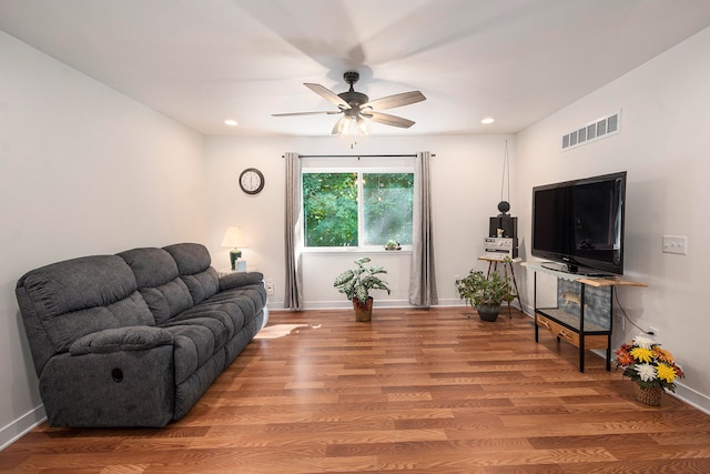 living room featuring ceiling fan and hardwood / wood-style flooring