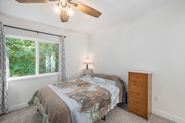 bedroom with ceiling fan and light colored carpet