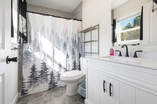 bathroom with tile patterned floors, curtained shower, vanity, and toilet