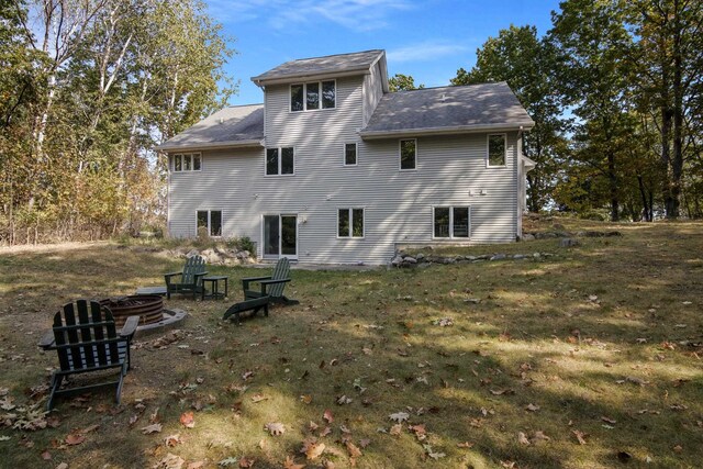 11826 Ridge View Dr, Rapid City, MI 49676 - back of property featuring an outdoor fire pit and a lawn