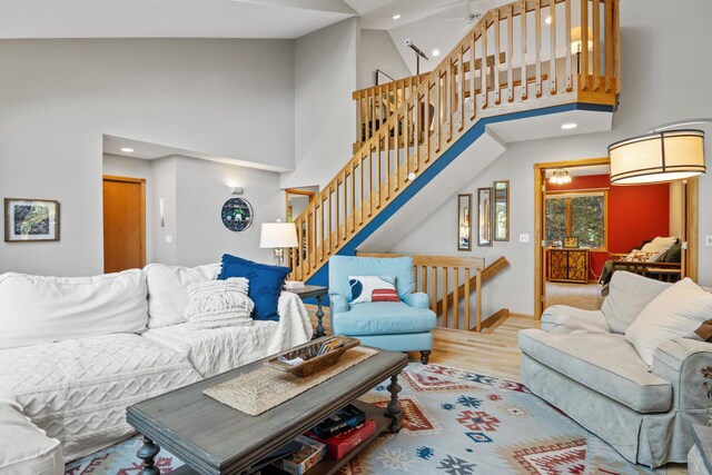 11826 Ridge View Dr, Rapid City, MI 49676 - staircase with high vaulted ceiling and a ceiling fan