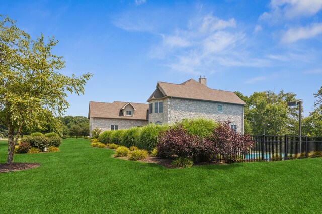 4559 Trails End Path, Saint Joseph, MI 49085 - view of side of home featuring stone siding and a chimney