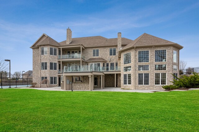 4559 Trails End Path, Saint Joseph, MI 49085 - back of house featuring a balcony, stone siding, a chimney, and a patio