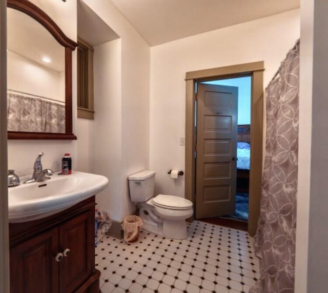 bathroom featuring tile patterned flooring, vanity, and toilet