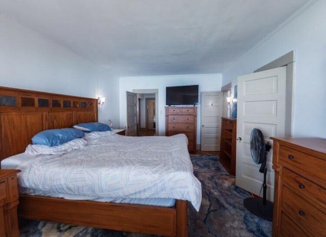 bedroom with dark colored carpet