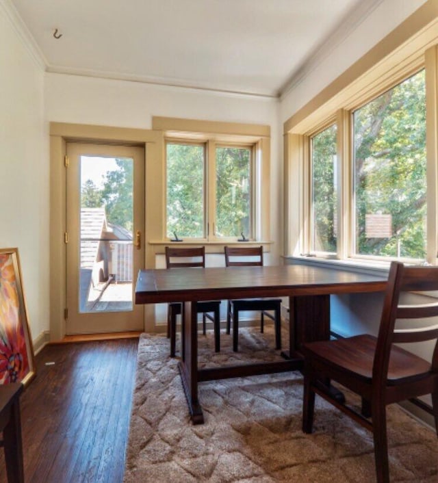 dining space featuring crown molding, plenty of natural light, and hardwood / wood-style floors