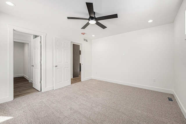 unfurnished bedroom with ceiling fan and carpet floors