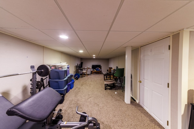 workout room featuring a drop ceiling and carpet floors