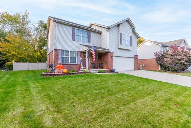 view of front property with a front yard and a garage