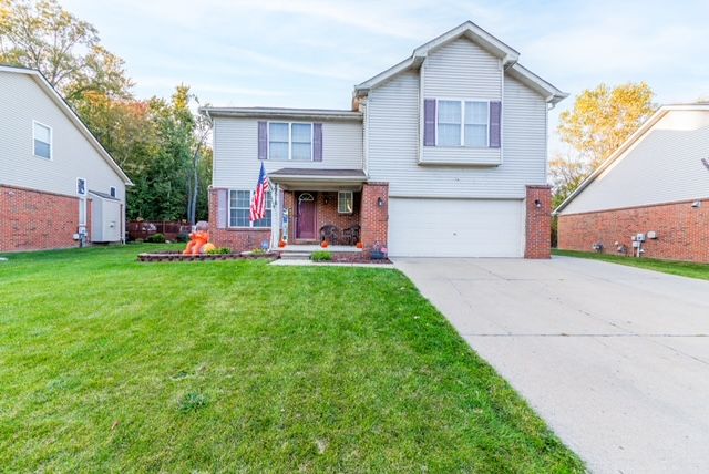 view of front property with a front lawn and a garage