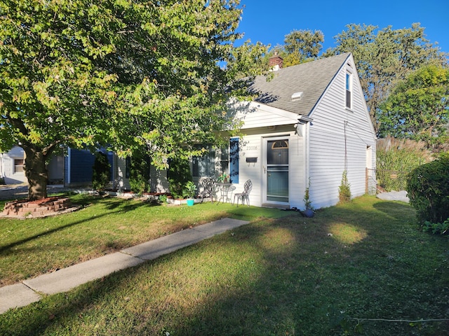 23006 Rosalind Ave, Eastpointe, MI 48021 - view of front of home featuring a front yard, a chimney, and a shingled roof