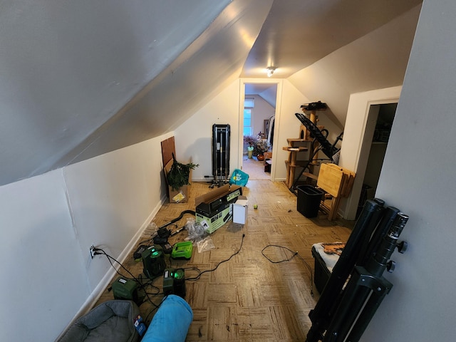 additional living space featuring light parquet floors and vaulted ceiling