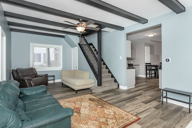 living room with beam ceiling, ceiling fan, and wood-type flooring