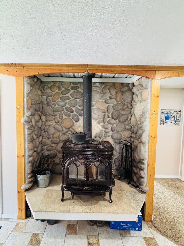 23390 Bluegill Rd, Sears, MI 49679 - detailed view of a wood stove and a textured ceiling