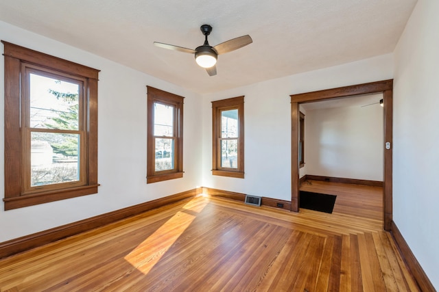 unfurnished room with hardwood / wood-style floors and ceiling fan