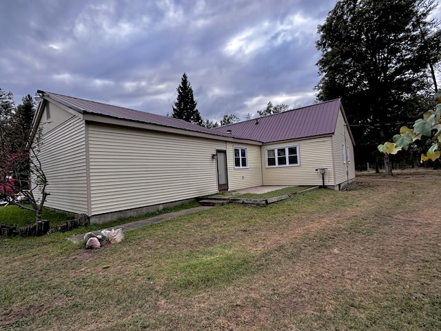 back of house with a lawn