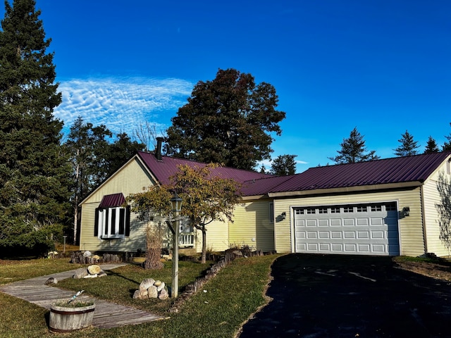 ranch-style house with a front yard and a garage