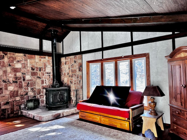 living room featuring hardwood / wood-style flooring, beam ceiling, a wood stove, and wooden ceiling