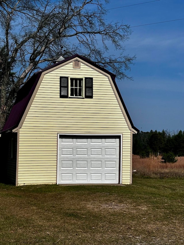 garage featuring a yard