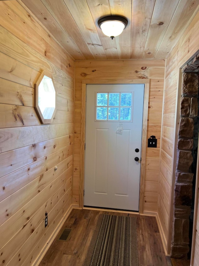 doorway featuring wood walls, wood-type flooring, wood ceiling, and a skylight