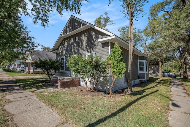 view of side of home featuring a lawn