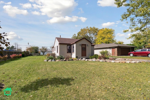 view of front of home with a front lawn and a garage