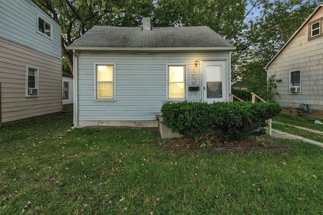 view of side of home featuring a lawn and cooling unit