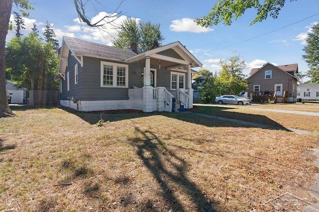 bungalow with a porch and a front yard