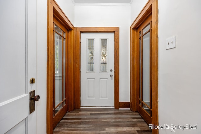 doorway to outside with crown molding and dark wood-type flooring