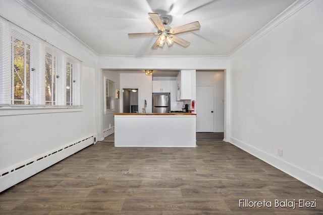 interior space featuring ornamental molding, dark hardwood / wood-style flooring, ceiling fan, and a baseboard heating unit