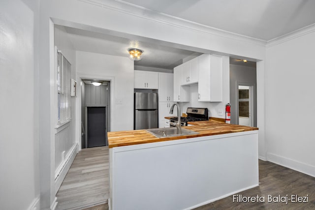 kitchen featuring hardwood / wood-style floors, stainless steel appliances, and butcher block counters