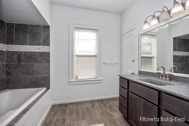 bathroom featuring a bath, wood-type flooring, and vanity