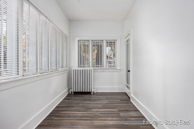 unfurnished sunroom featuring radiator heating unit