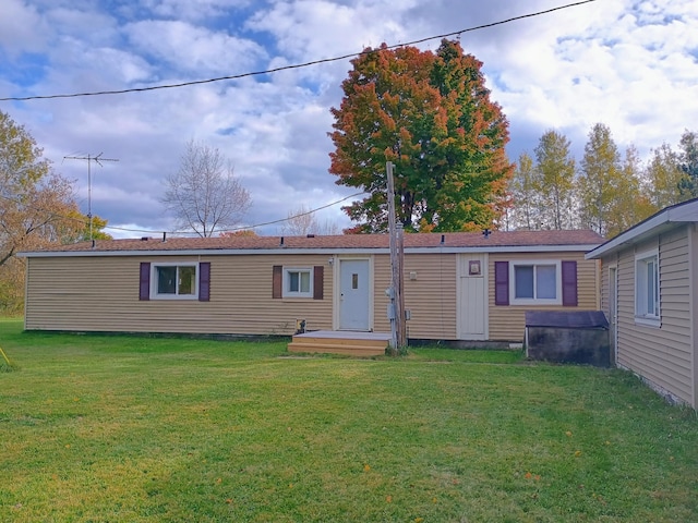 rear view of property with a yard