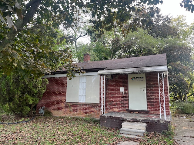 8900 Artesian St, Detroit, MI 48228 - view of front of home with brick siding and a chimney