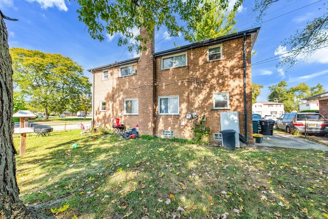 rear view of property with a yard